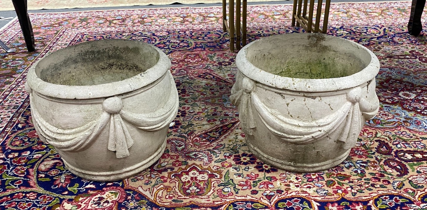 A pair of reconstituted stone circular garden planters with swagged bodies, diameter 38cm, height 30cm.